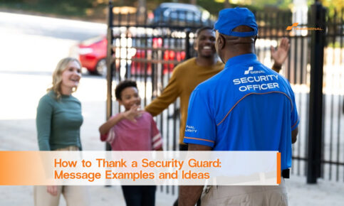 Security guard in a blue uniform greeting a smiling family at a gated entrance.