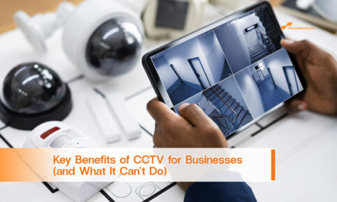 Person viewing business security CCTV feeds of corridors and stairwells on a tablet beside security cameras.