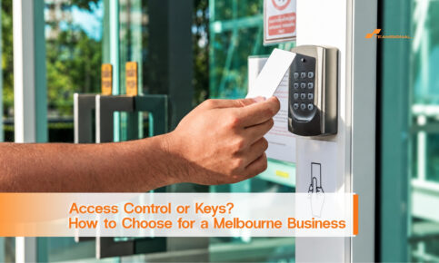 Hand holding a white access card beside a keypad reader at a glass office entrance.